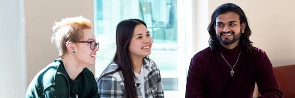 Three students sitting together in Centennial Hall