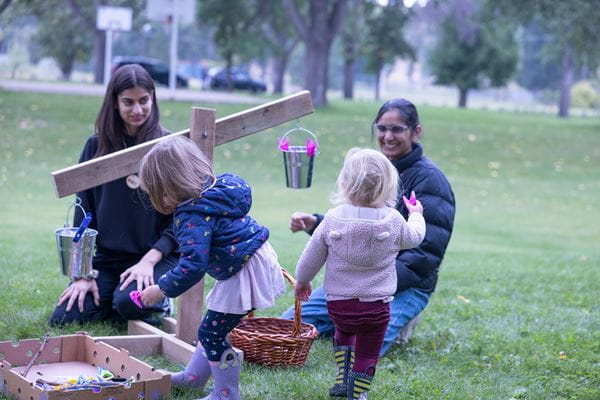 Medicine Hat College Early Learning & Child Care students help children explore balancing in their Outdoor Pedagogy class.