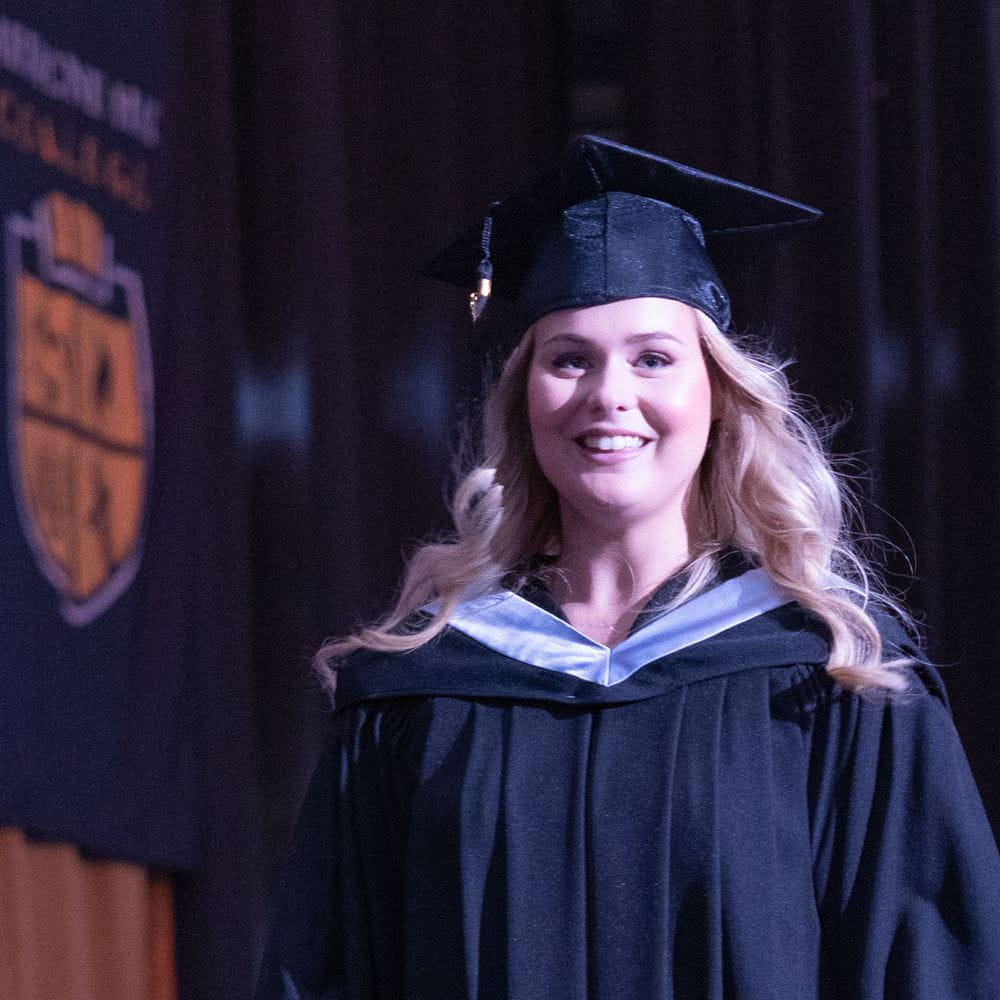 Student walks across the stage at convocation