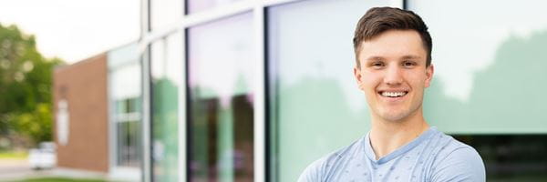 Student standing in front of MHC.