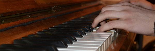 Close of up of person's hands playing the piano