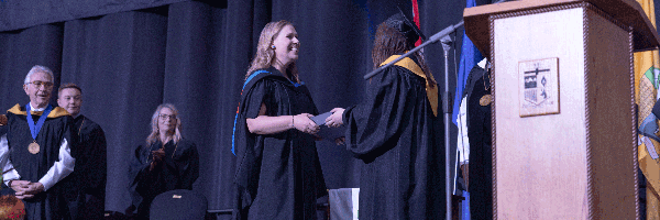 MHC instructor accepting award at convocation