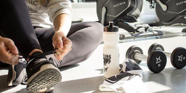 Close up of student tying shoes in the MHC Fitness Centre