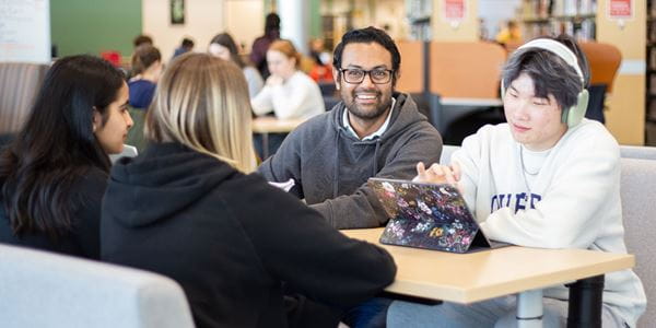 Four students studying in the library