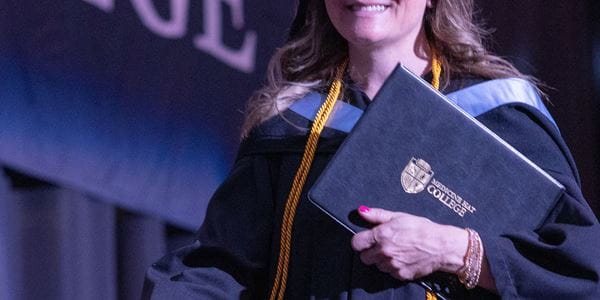 Close up of a women holding the MHC Diploma parchment.
